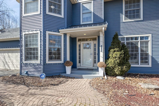 view of exterior entry with a garage