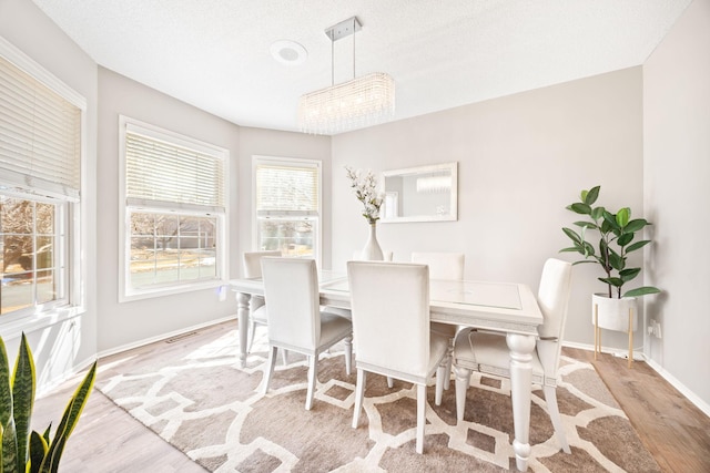 dining room with wood finished floors and baseboards