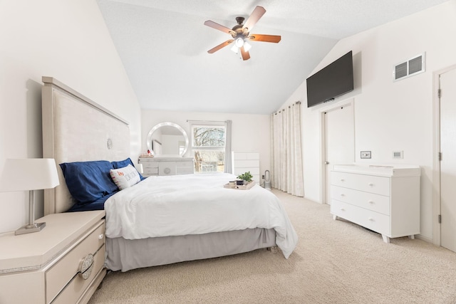 bedroom featuring visible vents, light colored carpet, ceiling fan, and vaulted ceiling