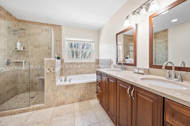 full bathroom with a shower stall, a garden tub, double vanity, and a sink