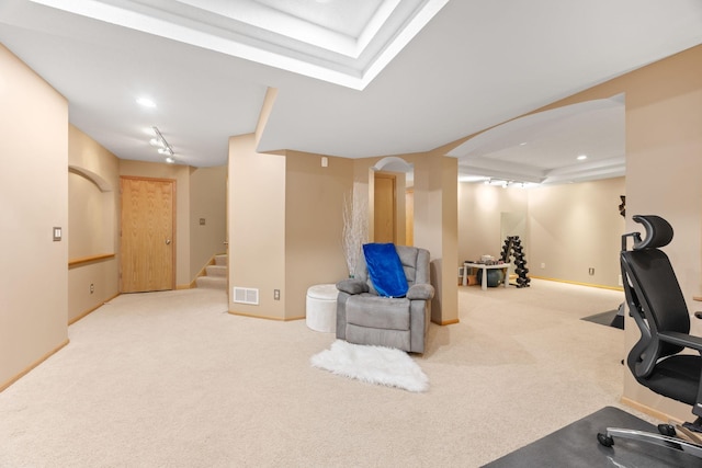 workout area featuring visible vents, carpet, arched walkways, and baseboards