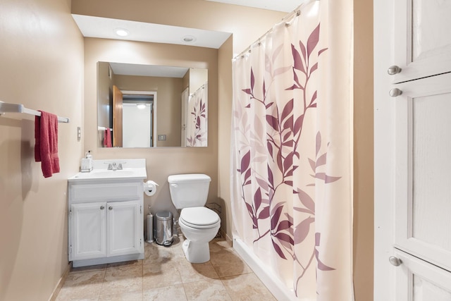 bathroom featuring toilet, a shower with shower curtain, tile patterned flooring, baseboards, and vanity