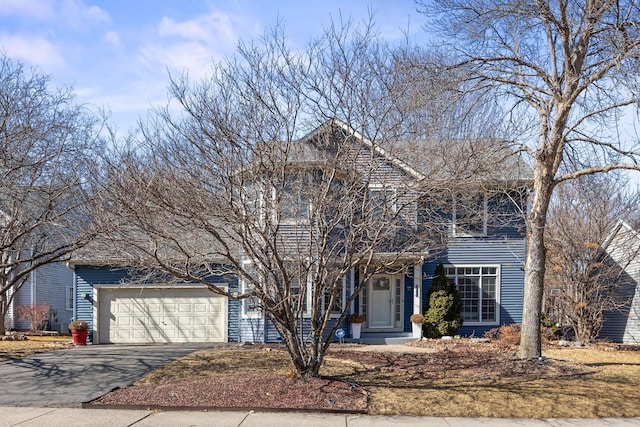 traditional-style house featuring driveway and an attached garage