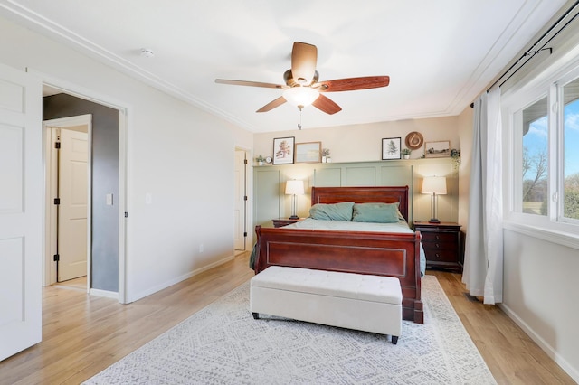 bedroom featuring baseboards, light wood-style floors, and ornamental molding