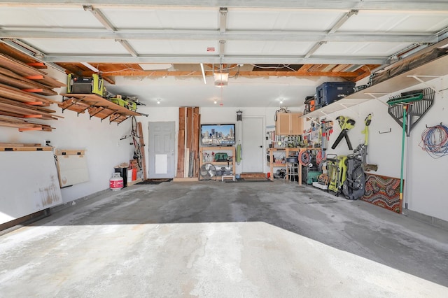 garage featuring a workshop area and a garage door opener