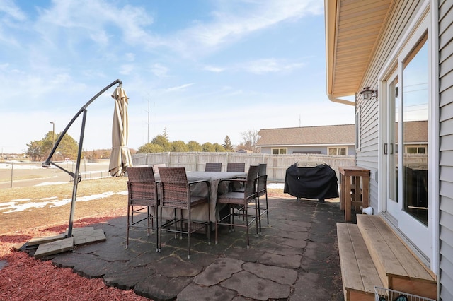 view of patio / terrace featuring outdoor dining area, a fenced backyard, and a grill