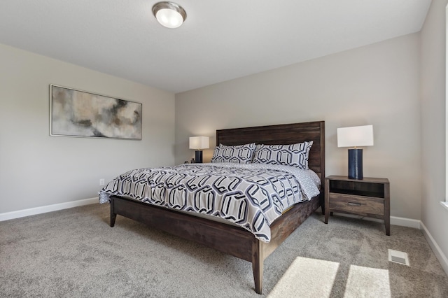 carpeted bedroom featuring baseboards and visible vents