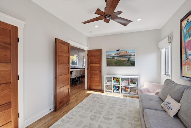 interior space with ceiling fan, baseboards, light wood-style flooring, and recessed lighting