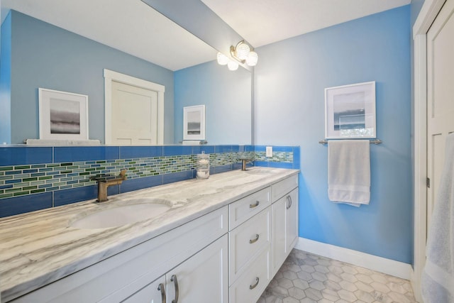 bathroom featuring double vanity, baseboards, backsplash, and a sink