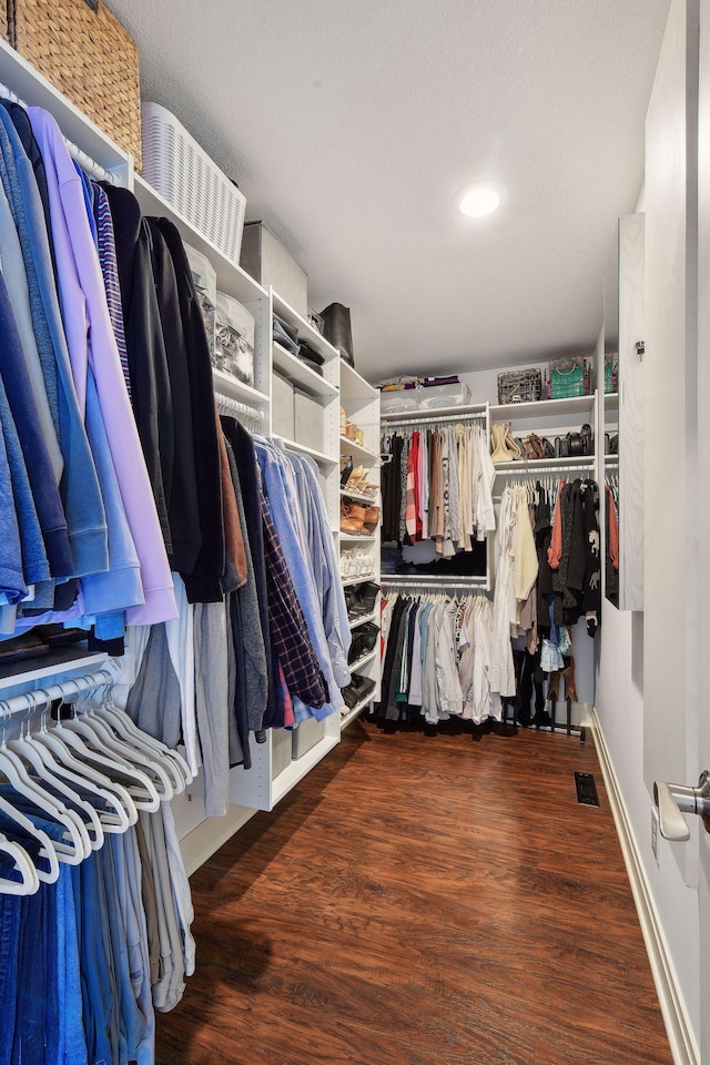 walk in closet with visible vents and wood finished floors