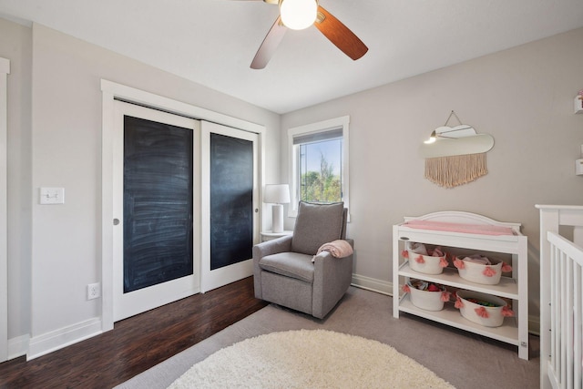 bedroom with a ceiling fan, baseboards, and wood finished floors