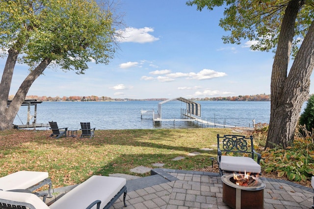 exterior space with a patio, a boat dock, a water view, and boat lift