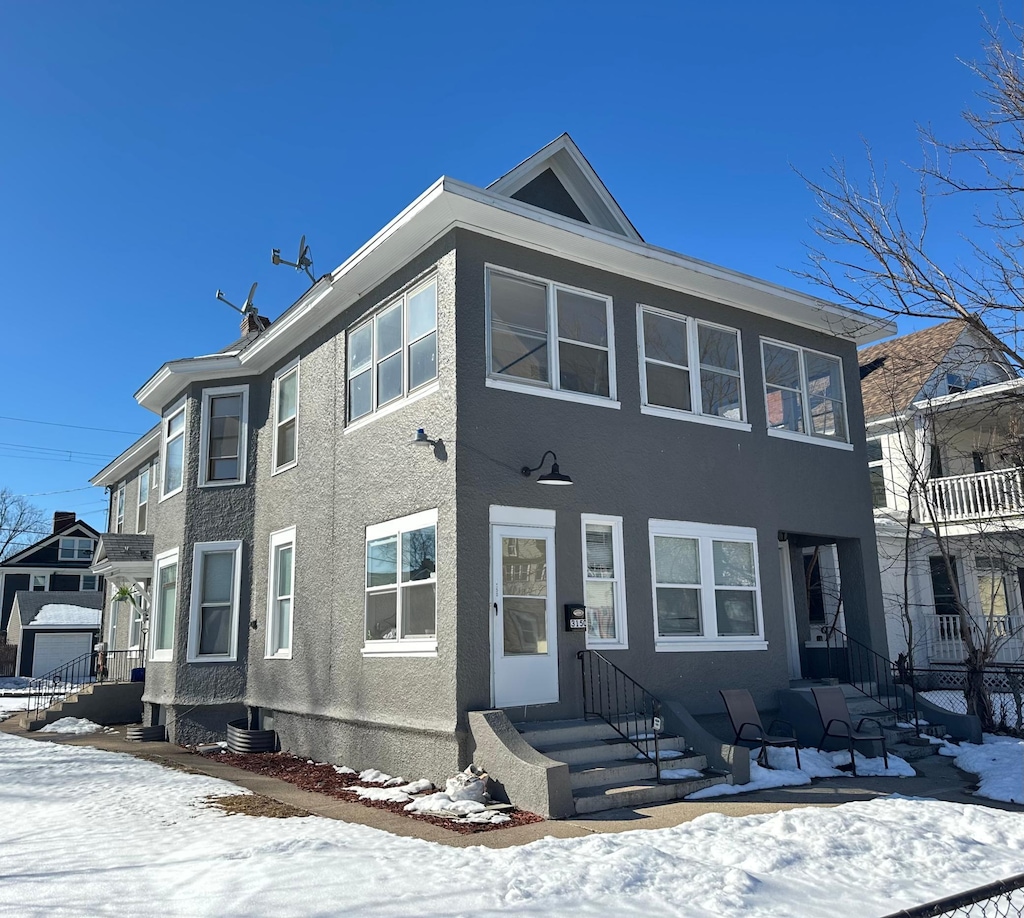 view of property featuring entry steps and stucco siding