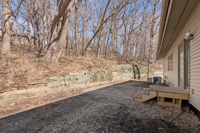 view of yard featuring cooling unit and a deck