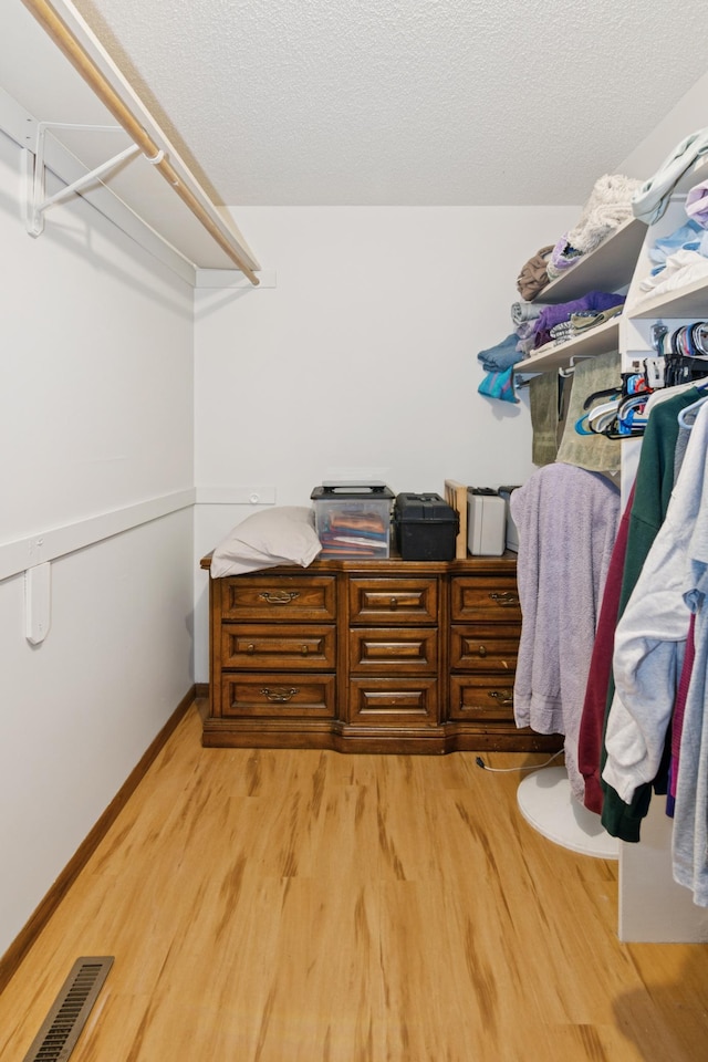 spacious closet with visible vents and light wood-style flooring