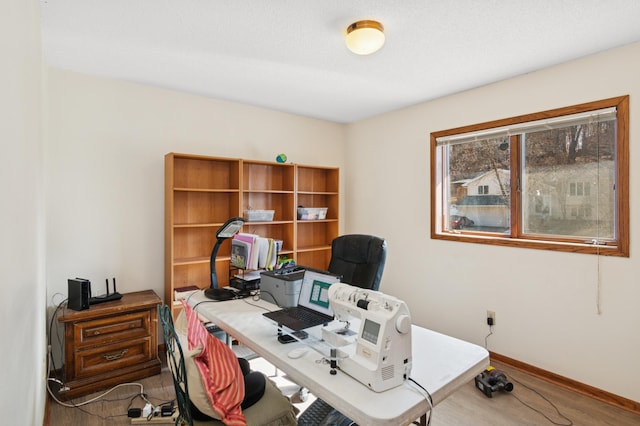 office area with baseboards and wood finished floors