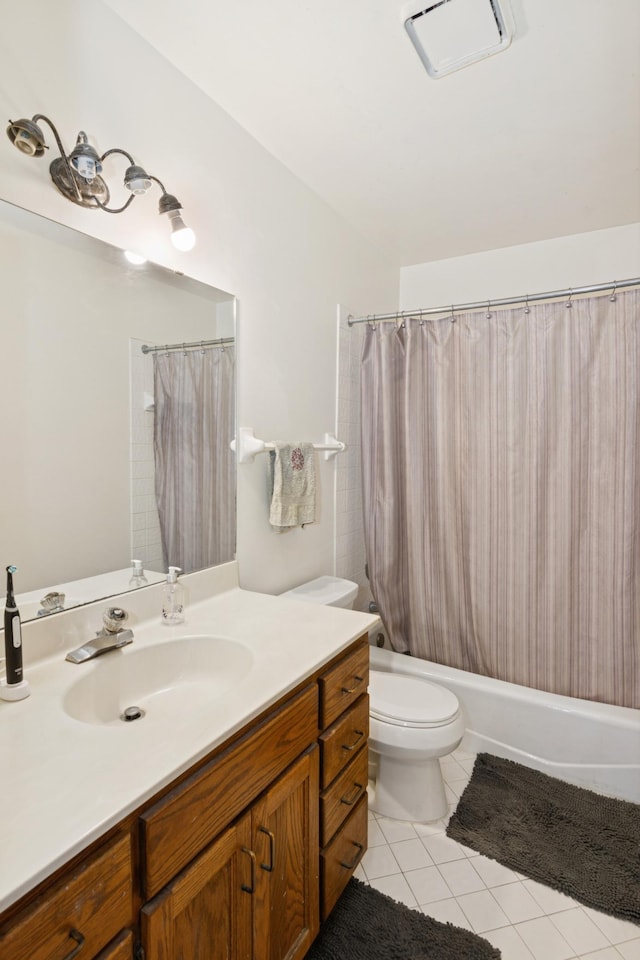 bathroom with vanity, tile patterned floors, toilet, and shower / bath combo with shower curtain