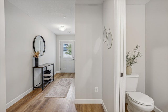 entryway with light wood-type flooring and baseboards