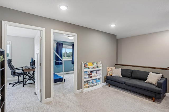 carpeted living area featuring recessed lighting and baseboards