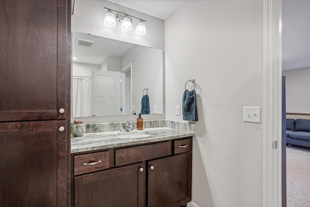 full bathroom with visible vents and vanity