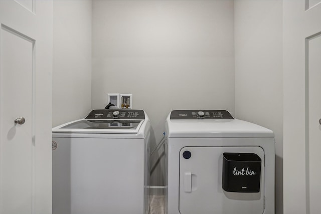 clothes washing area with washer and dryer and laundry area