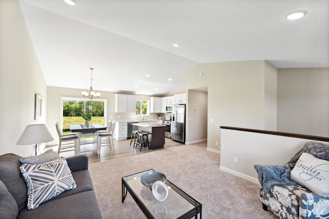 living room featuring a chandelier, recessed lighting, light colored carpet, baseboards, and vaulted ceiling