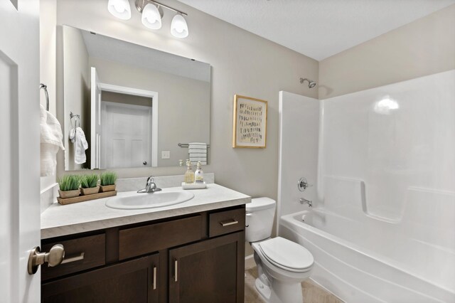 full bath with toilet, washtub / shower combination, and vanity