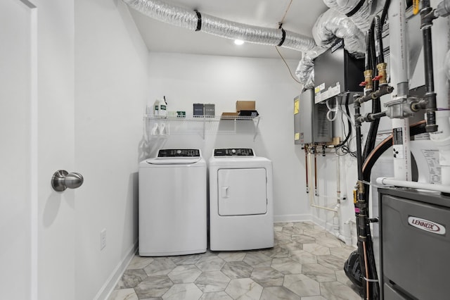 clothes washing area with laundry area, washer and clothes dryer, and baseboards