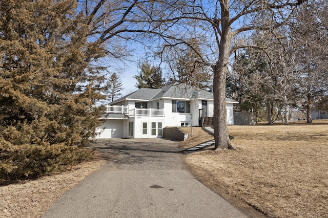 view of front of home with aphalt driveway and a garage