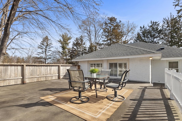 view of patio with outdoor dining area and a fenced backyard