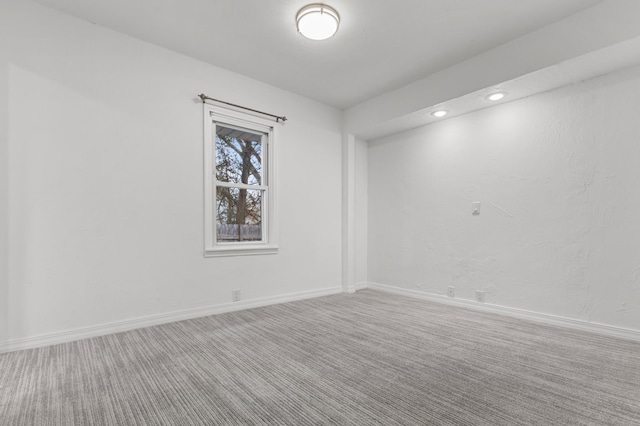 carpeted empty room featuring recessed lighting and baseboards