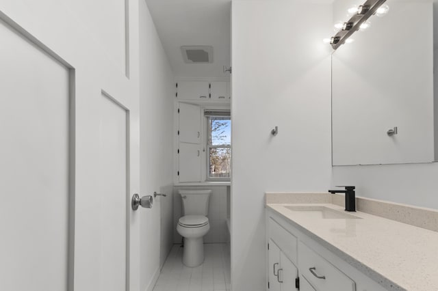 bathroom with vanity, visible vents, tile patterned floors, toilet, and tile walls