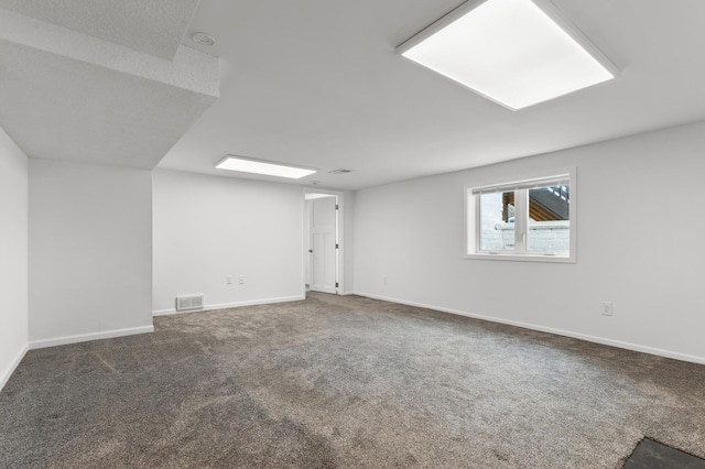 below grade area with visible vents, baseboards, and carpet