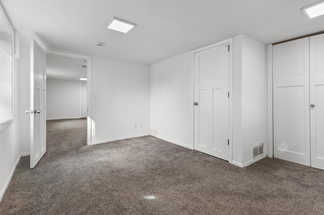 unfurnished bedroom featuring carpet, visible vents, and baseboards