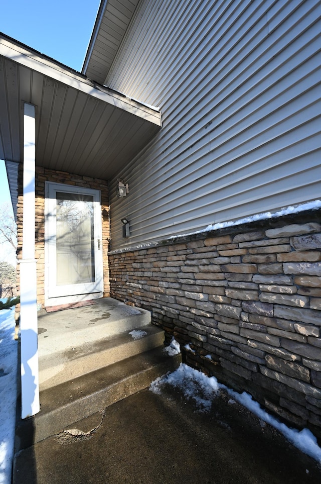 view of exterior entry with stone siding