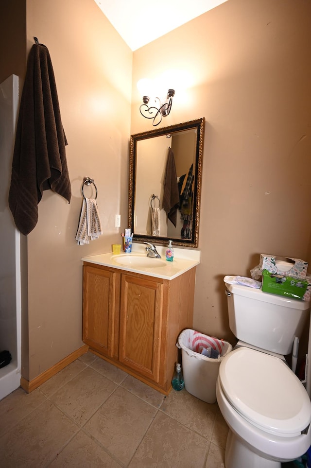 bathroom featuring tile patterned floors, toilet, vanity, and baseboards