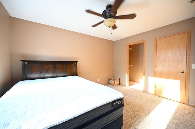 carpeted bedroom featuring baseboards and ceiling fan