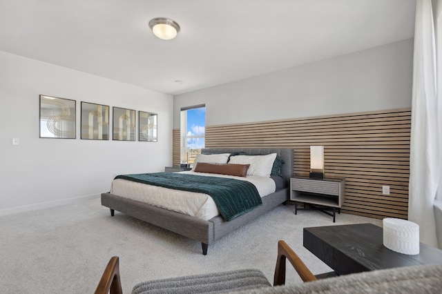 bedroom featuring carpet and baseboards