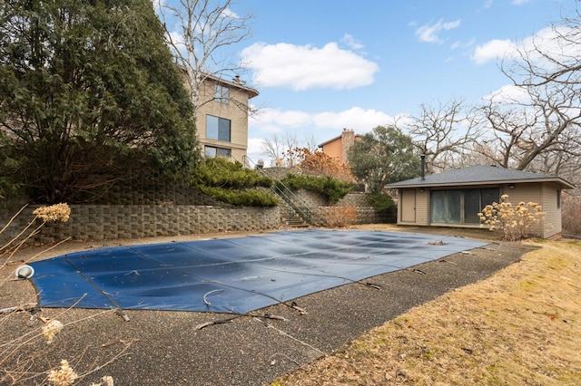 view of pool with stairway and a fenced in pool