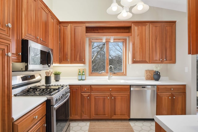 kitchen featuring light countertops, appliances with stainless steel finishes, and a sink