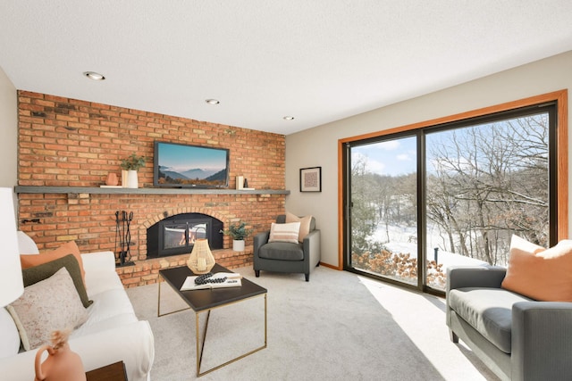 living room featuring carpet flooring, a fireplace, recessed lighting, and a textured ceiling