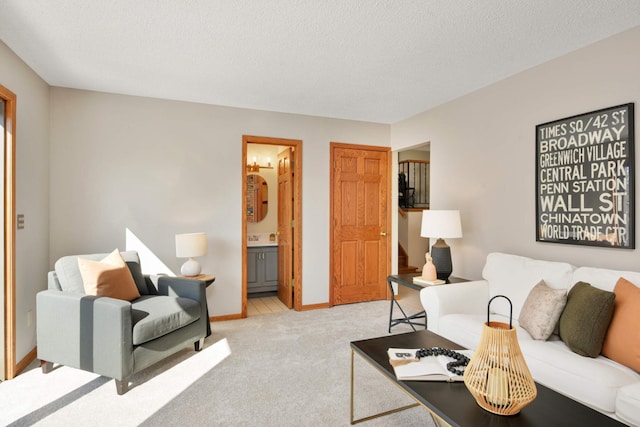 living room with baseboards, light carpet, and a textured ceiling