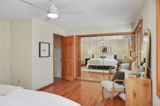 bedroom featuring a closet, a ceiling fan, and wood finished floors