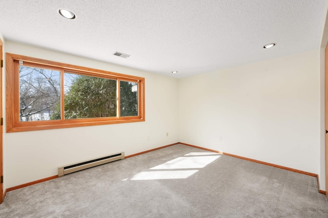 carpeted empty room with baseboards, visible vents, a baseboard radiator, recessed lighting, and a textured ceiling