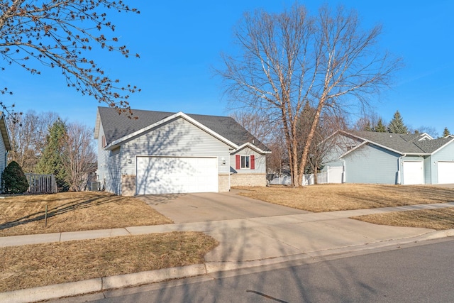 ranch-style house featuring driveway, fence, roof with shingles, a front yard, and an attached garage