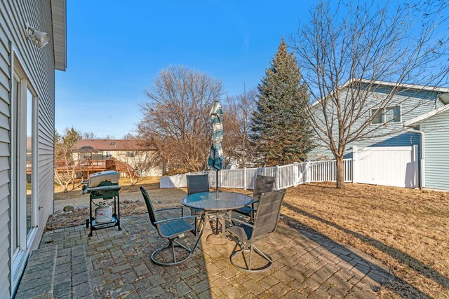 view of patio / terrace featuring area for grilling, outdoor dining space, and fence