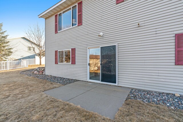 back of house with a patio and fence