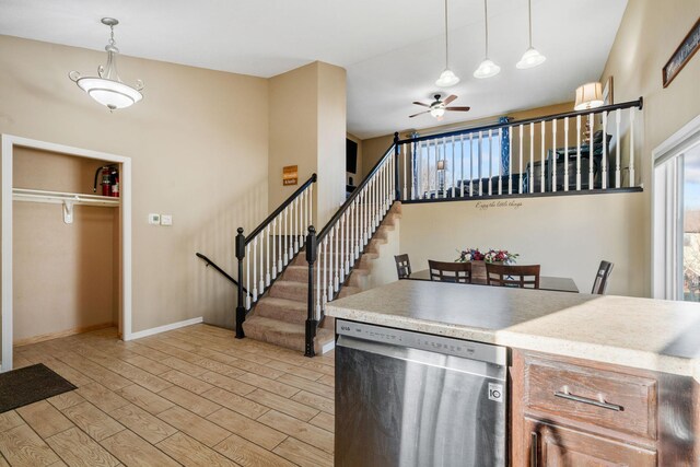 kitchen featuring light wood-type flooring, pendant lighting, a ceiling fan, light countertops, and dishwasher