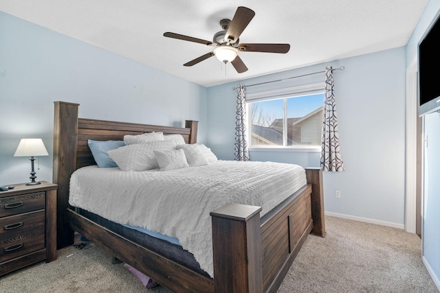 bedroom featuring a ceiling fan, baseboards, and light carpet