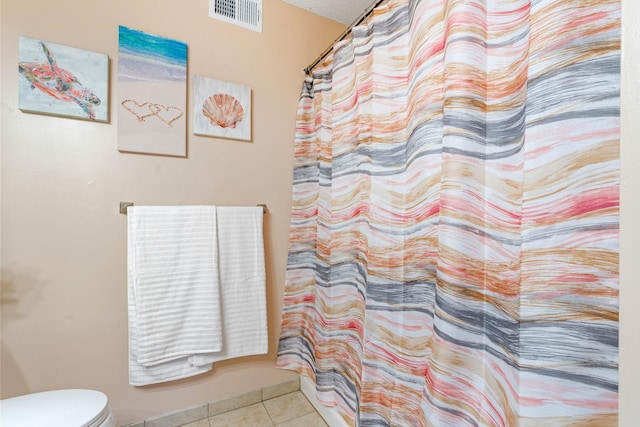 bathroom featuring tile patterned floors, visible vents, toilet, and a shower with curtain